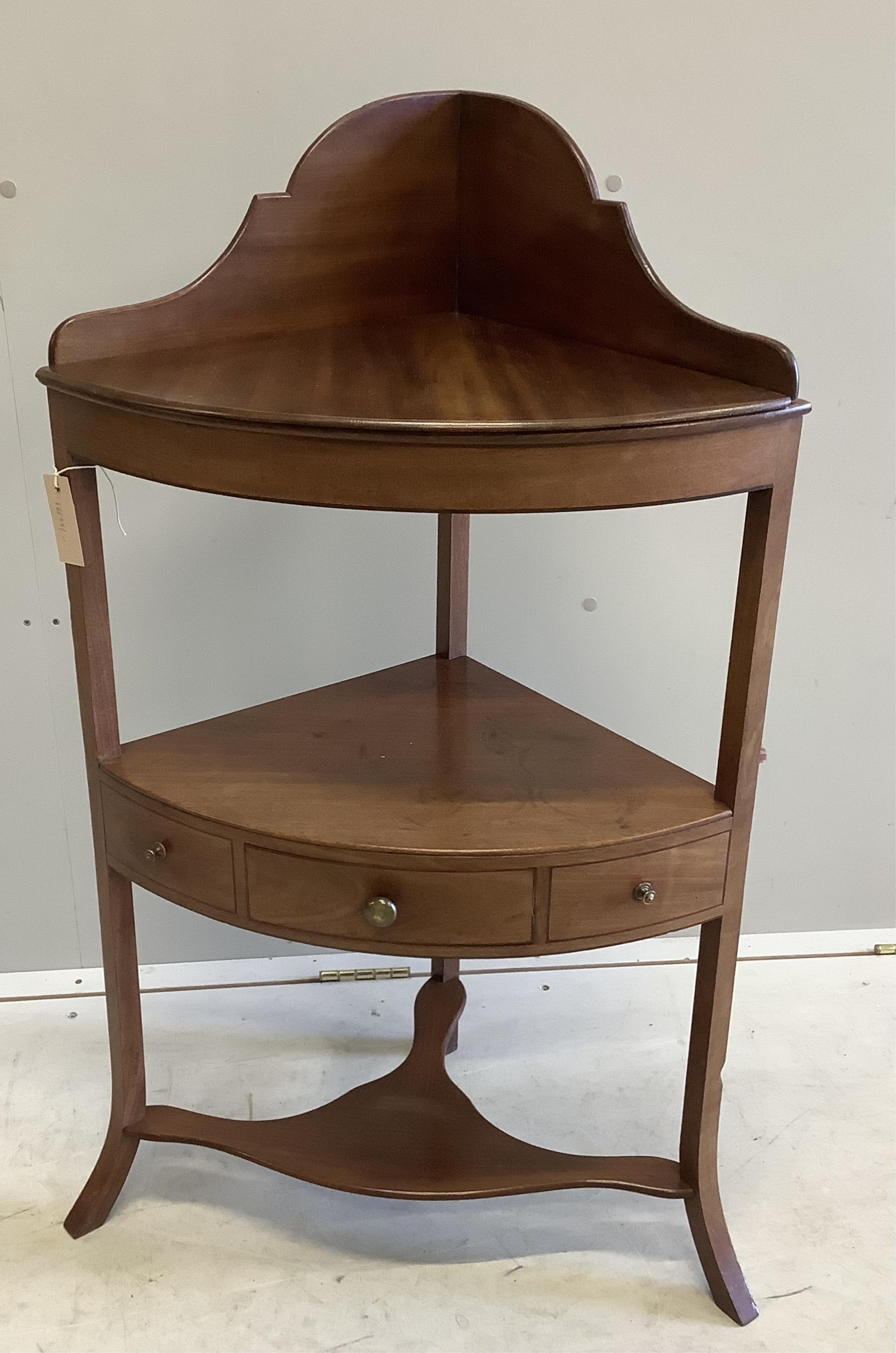 A George III mahogany two tier bow front corner washstand, width 57cm, depth 37cm, height 99cm. Condition - fair